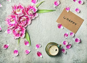 Pink Prints: Spring morning concept. Flat-lay of cup of coffee surrounded with pink tulip flowers