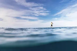Baby Boomer Prints: Stand up paddler paddles solo in the ocean of hawaii