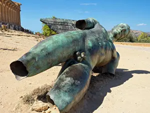 Sicily Prints: Statue of Icarus lies before the ancient Greek Concordia Temple near Agrigento in Sicily