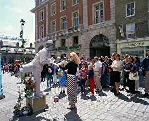 Square Prints: Statue street performer, and group of people watching