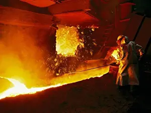 Molten Prints: A steel worker takes a sample from a blast furnace