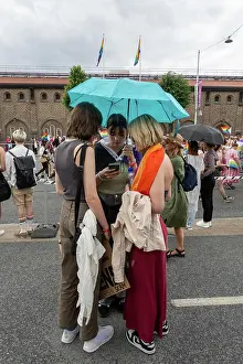 Swedish Prints: Stockholm, Sweden Three girls under an umbrella at the Stockholm Pride March 2024
