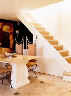 Tables Prints: Stone table and leather and metal chairs in modern country hall with open staircase
