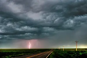 Shannon Prints: Storm with lightning flashing over highway in rural southern Manitoba Canada