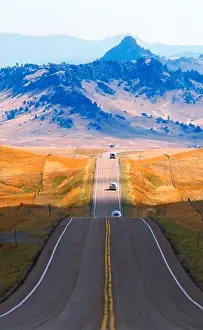 Straight Prints: Straight road reaching across plains of Montana toward Rocky Mountains