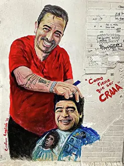 Cutting Prints: Street art by artist Cristian English shows Diego Maradona getting a haircut