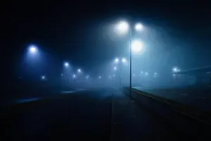 Ethereal Prints: Street lamps illuminated over foggy, vacant road