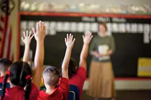 Students Prints: Students with their hands raised in a classroom