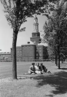Smart Prints: Three students sitting on grass outside university building