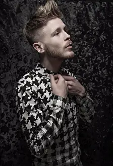 Studioshot Prints: Studio portrait of a bearded young man in a black and white shirt