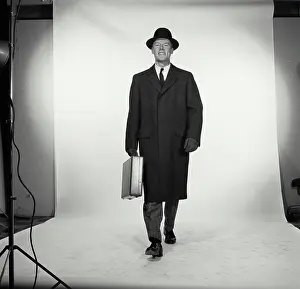 Shirt And Tie Prints: Studio portrait of businessman carrying briefcase