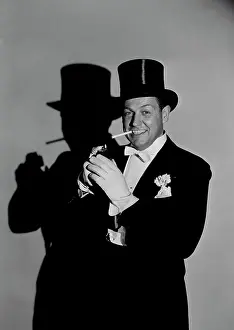 Smoking Prints: Studio portrait of man wearing tophat, smoking