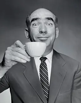 Beverage Prints: Studio portrait of mid adult man holding tea cup