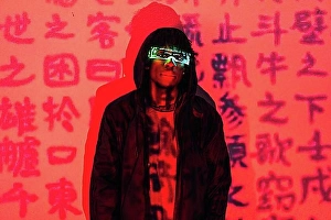 Luminous Prints: Studio portrait with red neon lights of a futuristic man with AR goggles in a wall with chinese words