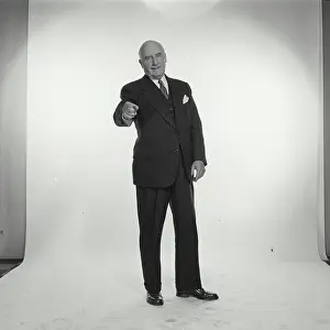 Business Suit Prints: Studio portrait of senior businessman pointing forward