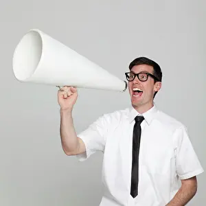 Shirt And Tie Prints: Studio portrait of young man with megaphone