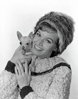 Warm Clothing Prints: Studio portrait of young woman embracing dog