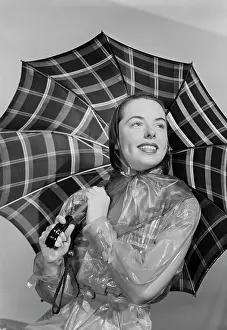 One Young Woman Only Prints: Studio portrait of young woman holding umbrella