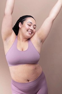 Bame Prints: Studio shot of smiling woman in underwear with eyes closed and arms raised