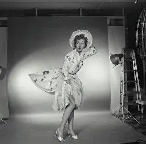 Formal Prints: Studio shot of woman in gress being blown by wind