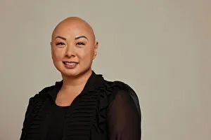 Bald Prints: Stylish bald woman with a warm smile