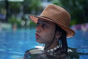 Asian And Indian Ethnicities Prints: Stylish trendy young teen visco girl in the pool wearing a straw hat