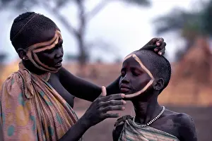 Sudan, Tribal People, Dinka Girl Decorating The Face Of A Friend Using Dung Ash Mixed With Water Or Cattle Urine