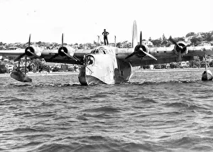 Air Vehicle Prints: Sunderland Flying Boat moving slowly up to a mooring buoy at Rose Bay delete air standards each ***** of man standing