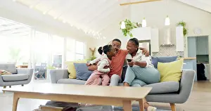 Cuddle Prints: Support, black family on sofa and in living room of their home happy together smiling