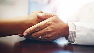 Kindness Prints: Support, doctor and holding hands of patient for care