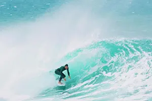 Surfer riding wave in sea