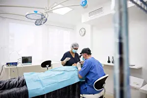 Small Group Prints: Surgeon sutures the eyelid after plastic surgery operation