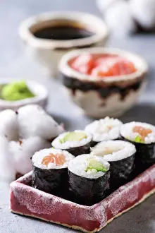 Pink Prints: Sushi rolls set in pink ceramic serving plate with bowls of soy sauce and pickled ginger