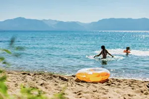 Swimming in a Mountain Lake with Blue Skies and an Orange Inflatable