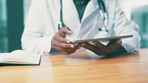 Doctors Prints: Tablet, notebook and hands of doctor in clinic with medical research for treatment planning