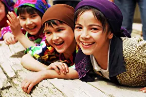 School Children Prints: Tajikistan, Penjakent, group of local girls in traditional dress posing and playing by the river on wooden bridge