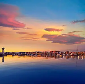 Atmospheric Light Prints: Tarragona port sunset with sea reflection in Catalonia