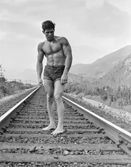 Bodybuilder Prints: Tattooed Shirtless Bodybuilder on Railroad Tracks c.1949