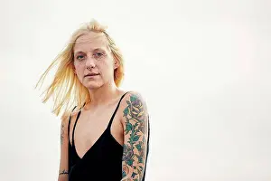 Upper Body Prints: Tattooed young woman against clear sky