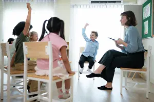 Freude Prints: Teacher and students, Learn and study in a classroom of school where youngsters sit and listen attentively