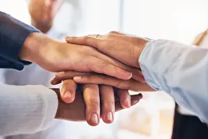 Innovation Prints: Teamwork, support and motivation with hands of business people for community