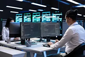 Electronics Prints: Technicians in data center workspace running system diagnostic tests and error checking utilities to fix problems