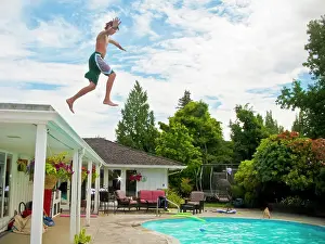 Domestic Dogs Prints: Teen boy jumping off roof into pool