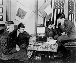 Listening Prints: Four teenage boys listening to a radio using headphones