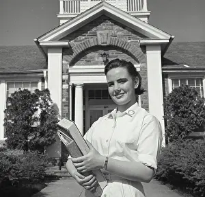 Adolescence Prints: Teenage girl holding books and smiling