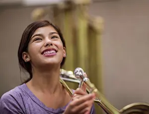 Students Prints: Teenage girl learning to play trombone