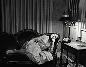 Landline Prints: Teenage girl lying on a couch and talking on the telephone
