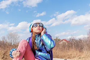 People In Nature Prints: Teenage girl in mirrored sunglasses looks into the sky