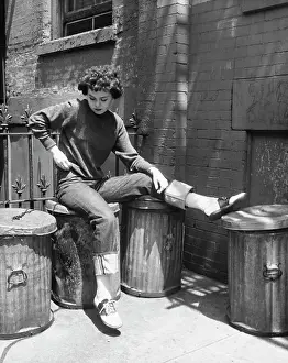 Denim Prints: Teenage girl sitting on a garbage bin