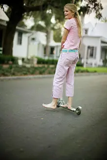 Recreation Prints: Teenage girl standing barefoot on a push scooter